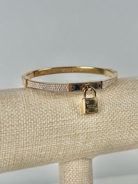 Michael Kors Brilliance Gold Plated Crystal Hinged Bracelet, Logo Pad Lock Charm